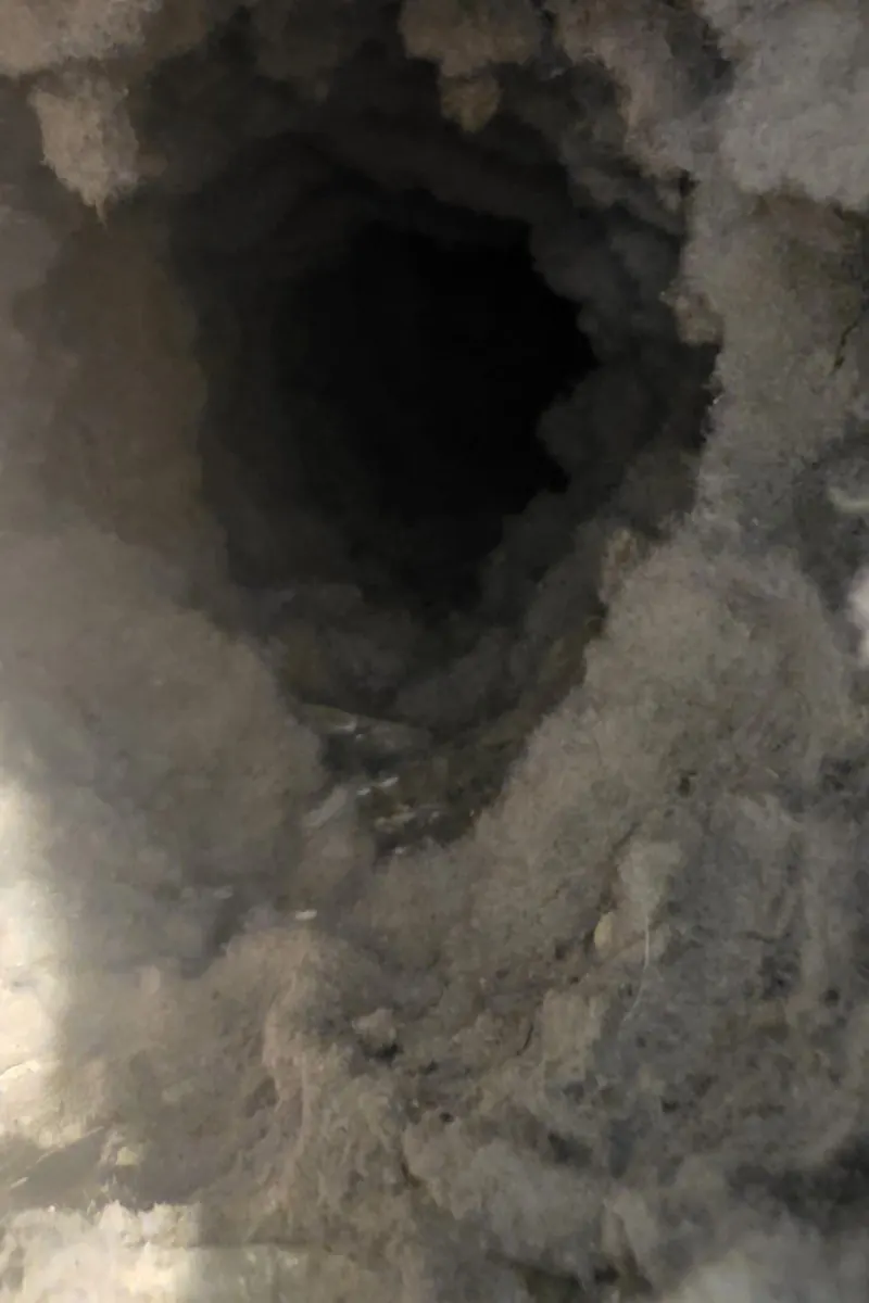 Clogged dryer vent before cleaning - heavy dangerous lint buildup